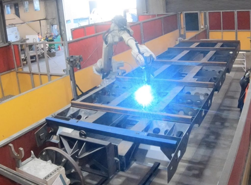 Robot welding a chassis at TRT