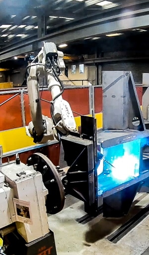 Robot welding a chassis at TRT